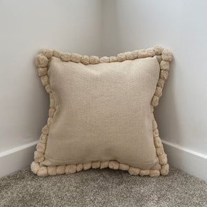 cream pre-stuffed cushion with textured design and pompoms sold by alba gu brath in dunfermline, scotland